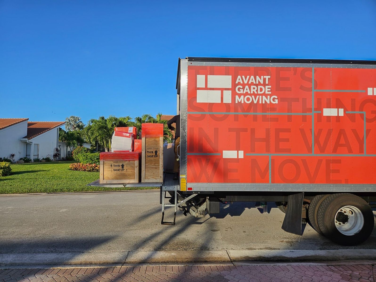 truck with labeled boxes and furniture on a lift gate, organized for transport to our secure storage