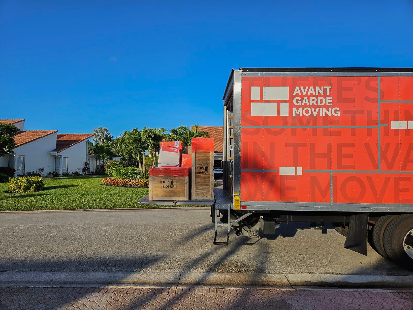 avant-garde moving truck parked on the street in Florida, during long-distance move from Manhattan