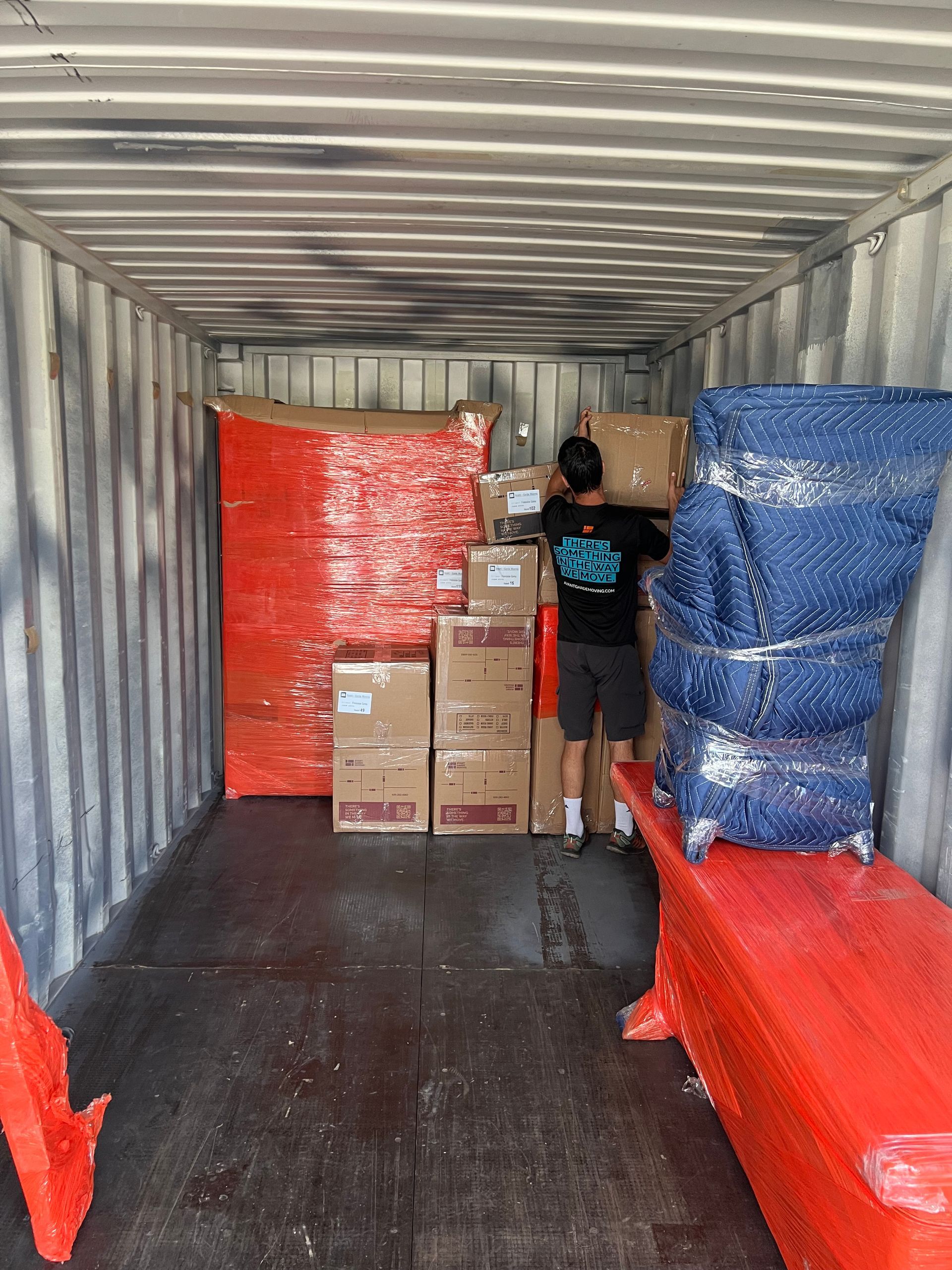 mover stacking up furniture in a moving pod (container) getting ready to be shipped overseas