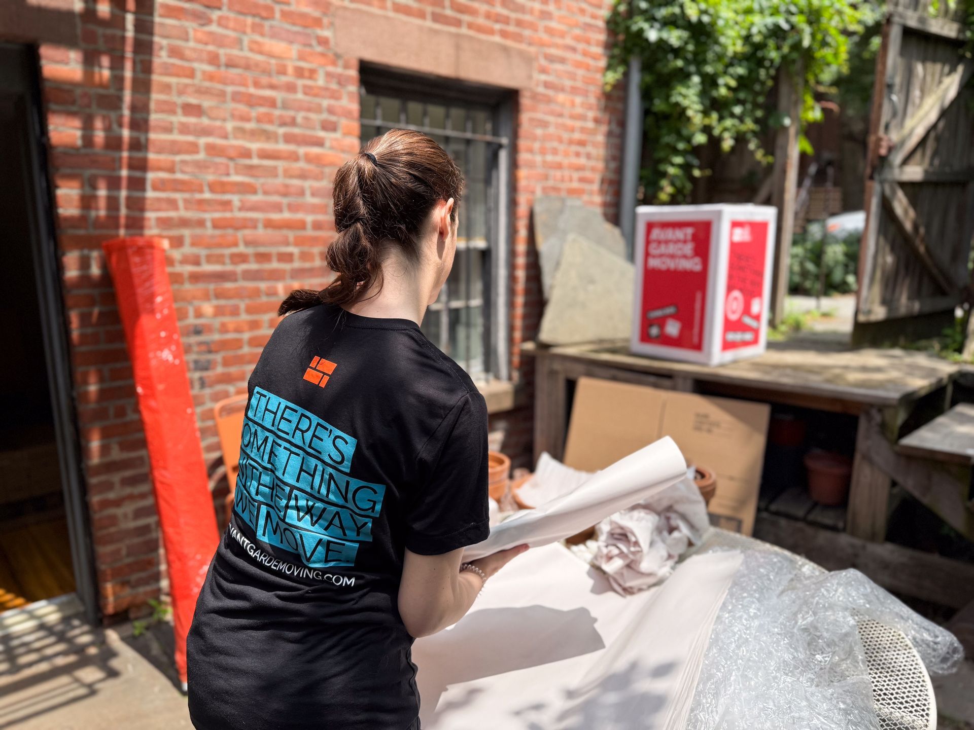 Avant-garde packer packing up pots in Brooklyn backyard