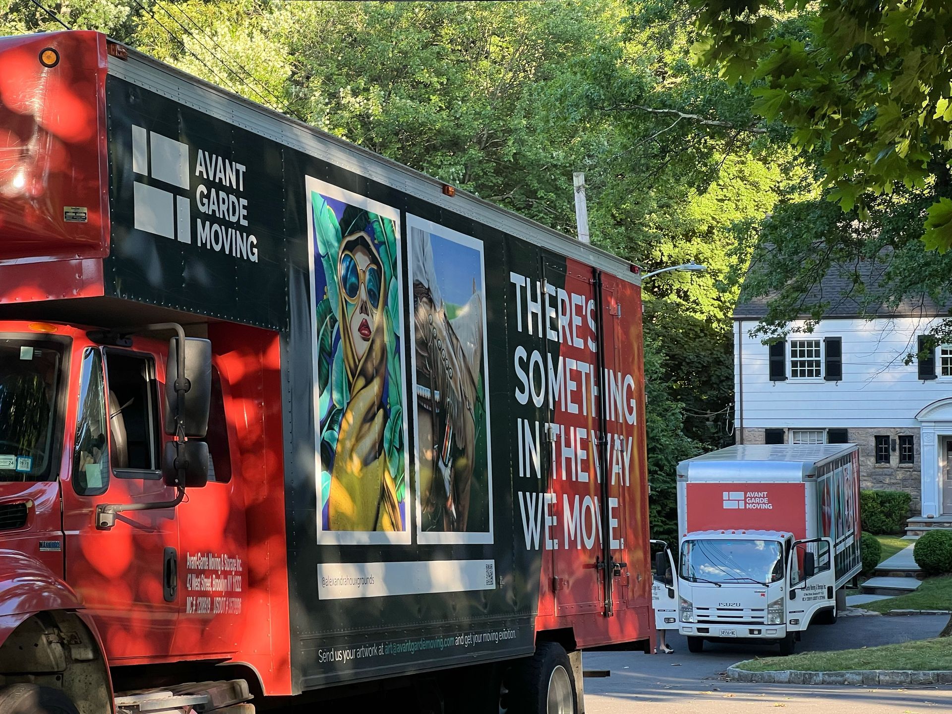 photo of avant-garde trucks in front of the customers house