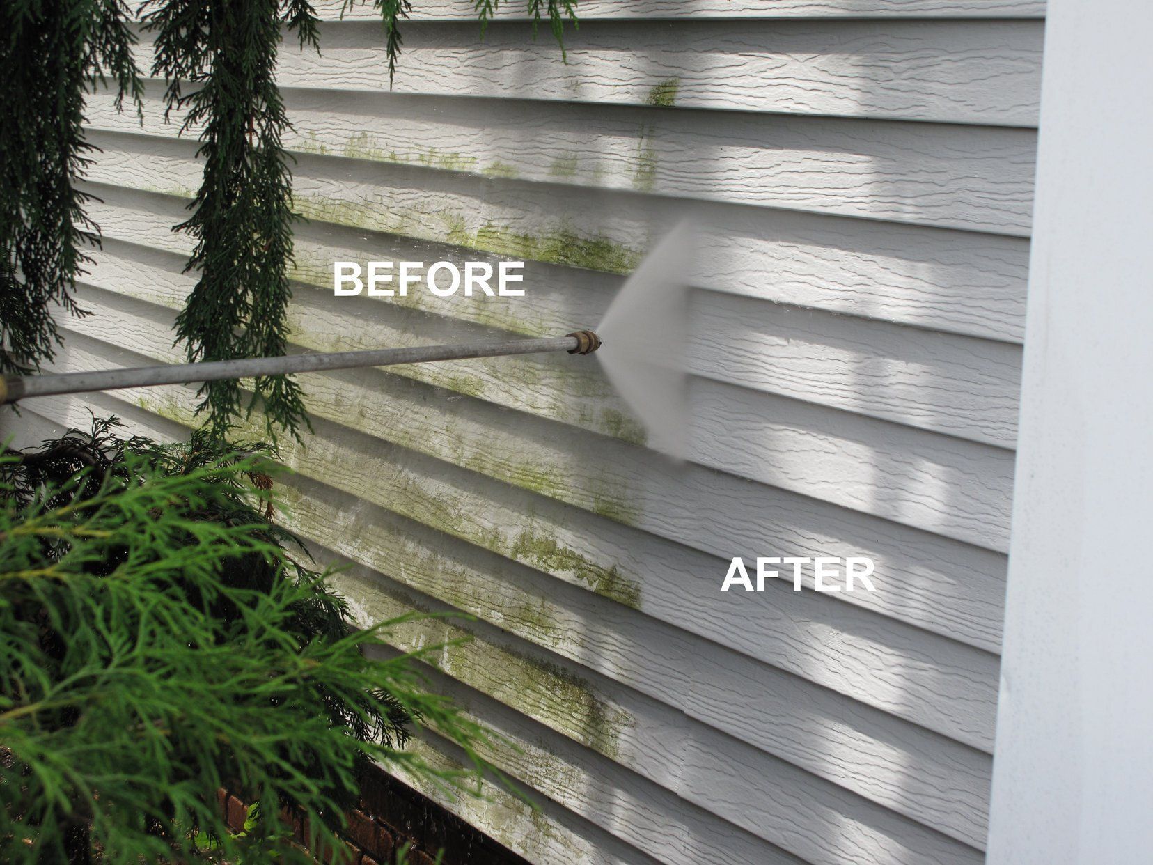 A before and after picture of a house siding being cleaned with a pressure washer.