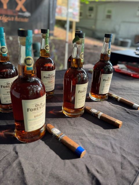 Guests at Pat’s Bar & Grill enjoying Whiskey & Cigar Night on the patio with fire pits, drinks, and a relaxed summer evening atmosphere.