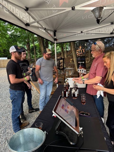 Guests at Pat’s Bar & Grill enjoying Whiskey & Cigar Night on the patio with fire pits, drinks, and a relaxed summer evening atmosphere.
