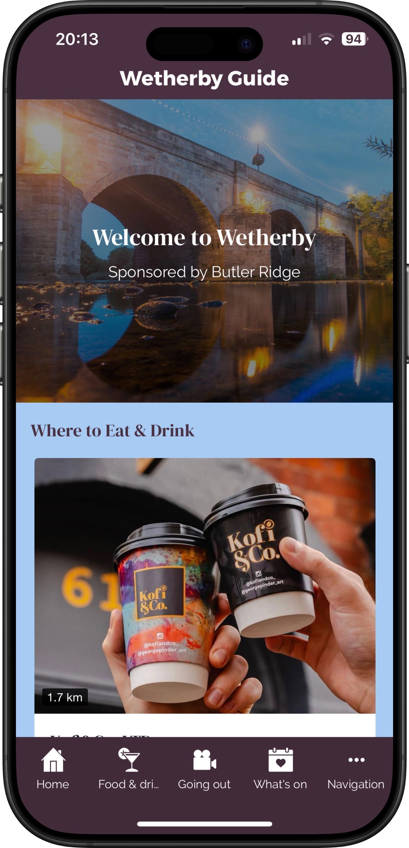 A person is holding two cups of coffee on a cell phone.