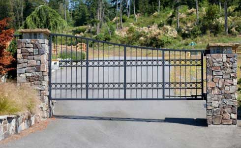 A Black Wrought Iron Gate Is Open To A Driveway – Mishawaka IN - Milestone Fence
