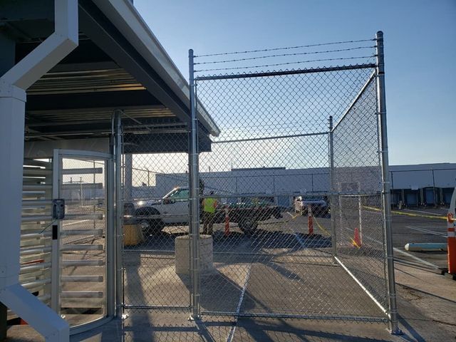 A Chain Link Fence Is In Front Of A Building – Mishawaka IN - Milestone Fence