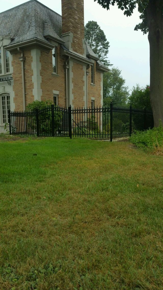 A Large House With A Fence Around It And A Large Lawn In Front Of It – Mishawaka IN - Milestone Fence