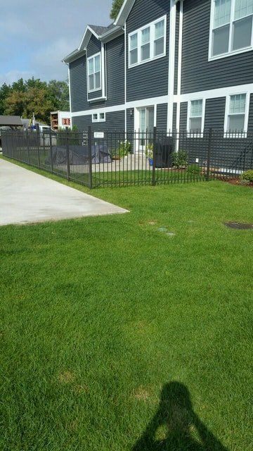 A Shadow Of A Person Is Cast On The Grass In Front Of A House – Mishawaka IN - Milestone Fence