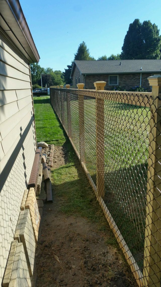 A Chain Link Fence Along The Side Of A House – Mishawaka IN - Milestone Fence