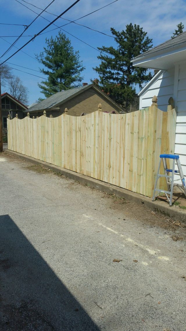 A Wooden Fence Is Being Built In The Backyard Of A House – Mishawaka IN - Milestone Fence
