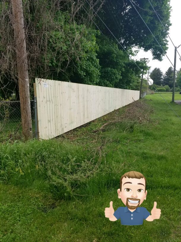 A Man Is Giving A Thumbs Up In Front Of A Wooden Fence – Mishawaka IN - Milestone Fence