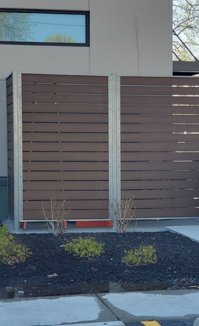 A Wooden Fence Is Sitting In Front Of A Building – Mishawaka IN - Milestone Fence