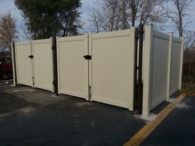 A White Fence With A Black Gate In A Parking Lot – Mishawaka IN - Milestone Fence