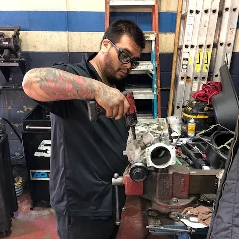 Car Suspension — Mechanic Working on Car Parts in Chicago, IL