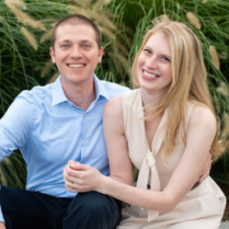A man and a woman are sitting next to each other and smiling