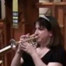 A woman is playing a trumpet in a church.