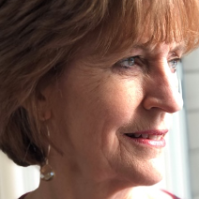 A close up of a woman 's face with a smile on her face.