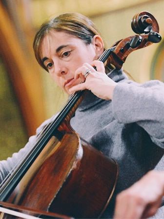 A woman is playing a cello with a ring on her finger