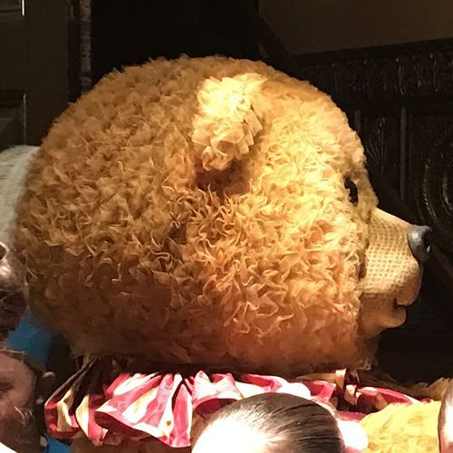 A teddy bear with a red and white scarf around its neck