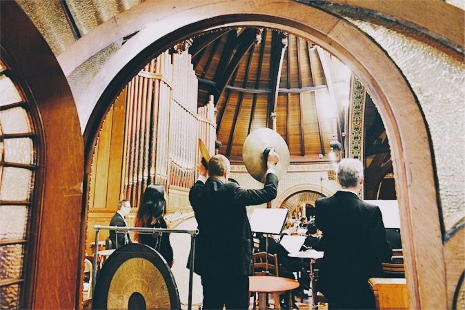 A group of men are playing instruments in a church