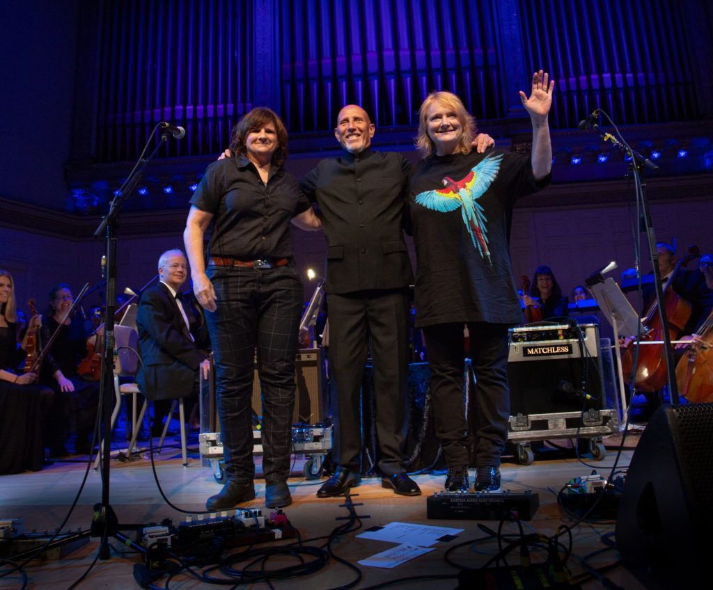 A group of people are posing for a picture on a stage.