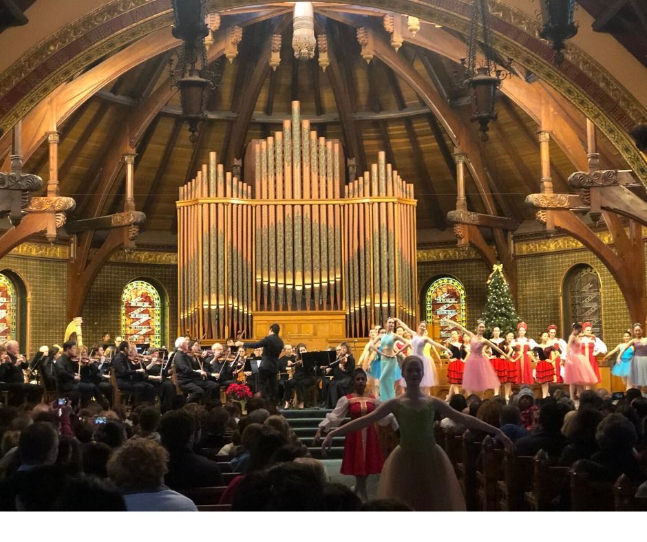 A group of people are dancing in front of an organ in a church