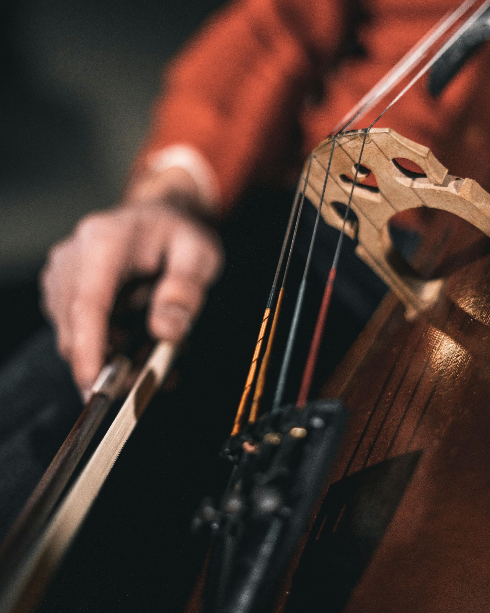 A close up of a person playing a violin