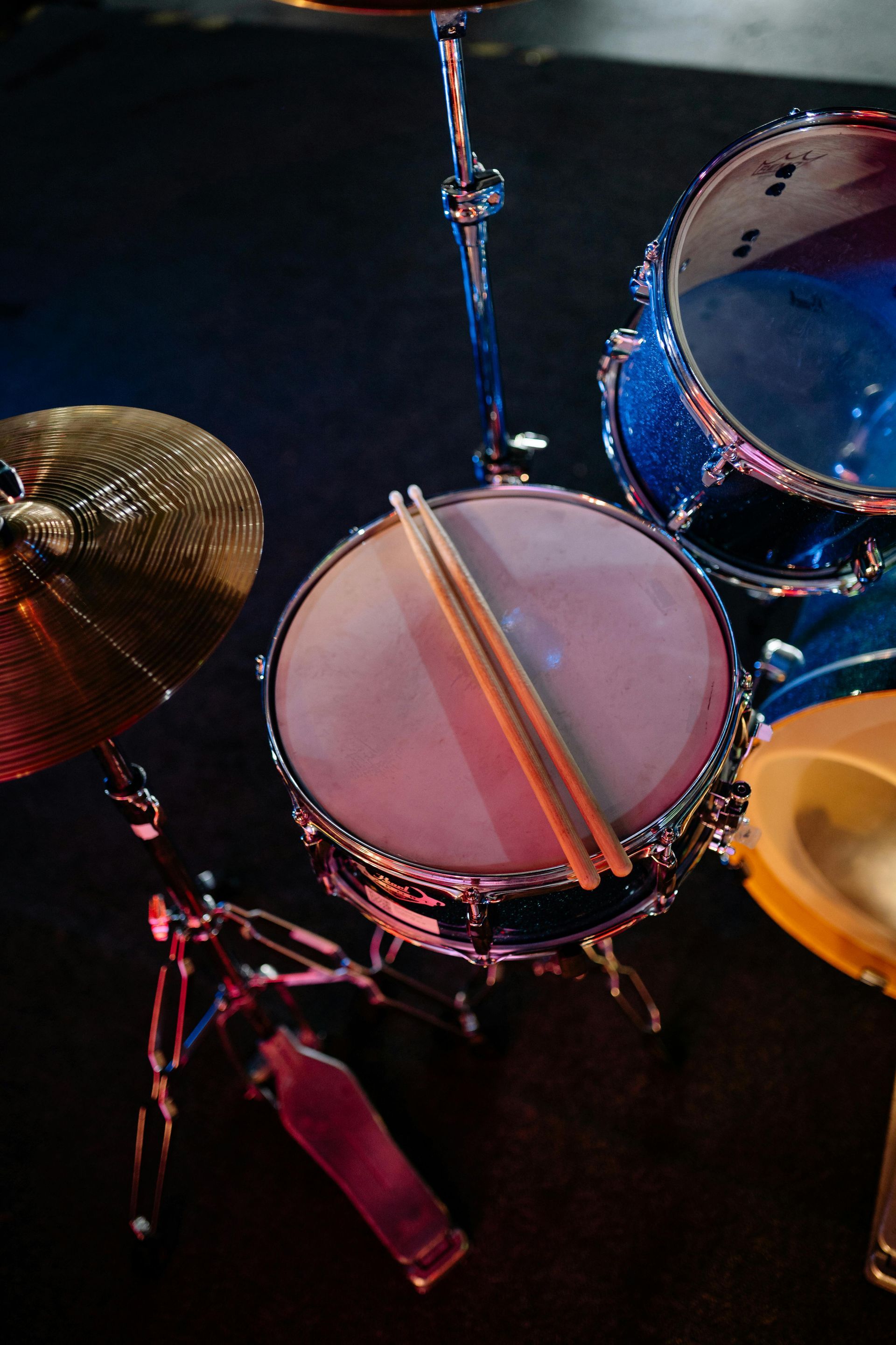 A close up of a drum set with drumsticks on it