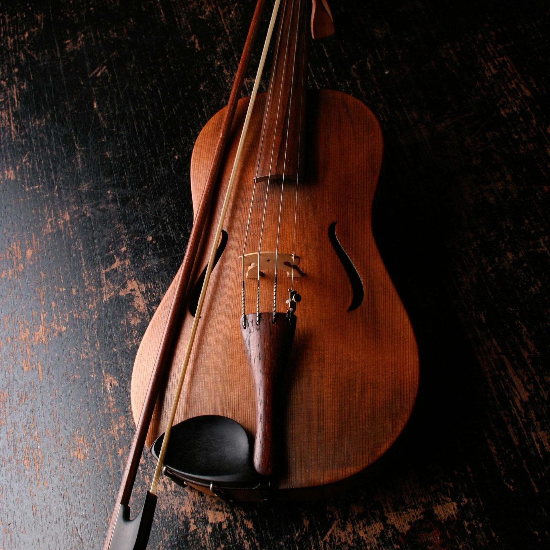 A violin with a bow is sitting on a table