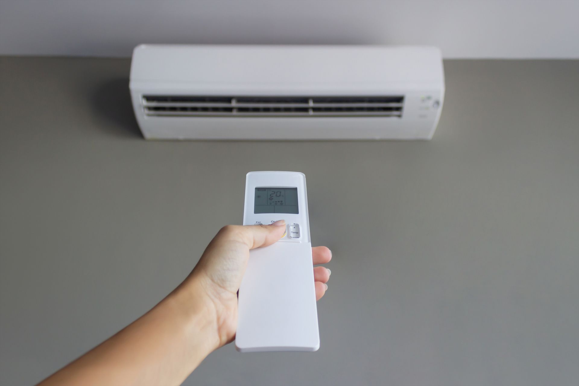 A Person Is Holding a Remote Control in Front of an Air Conditioner | Doncaster, VIC | Blain-air Heating & Cooling