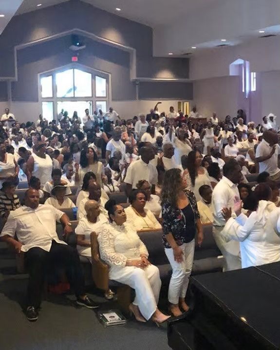 A large group of people are gathered in a church