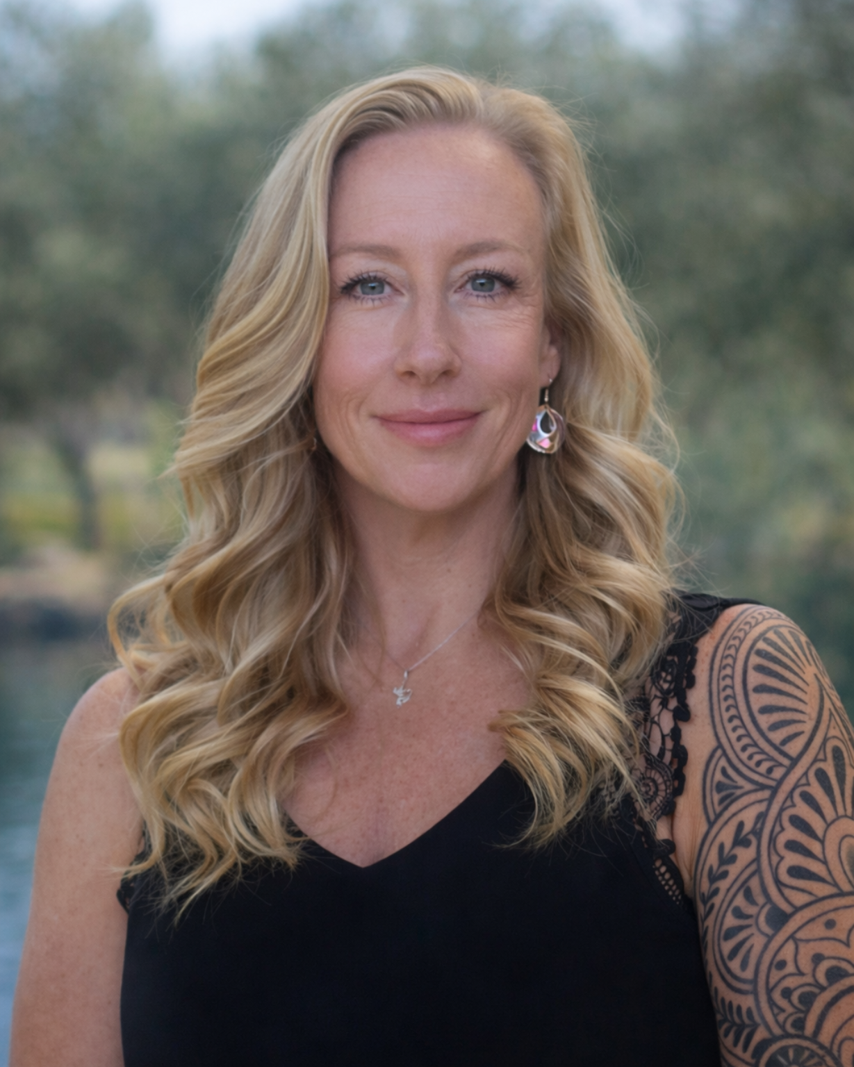 A wide view of a modern, multi-story office building with a glass facade, seen from a street-level perspective.