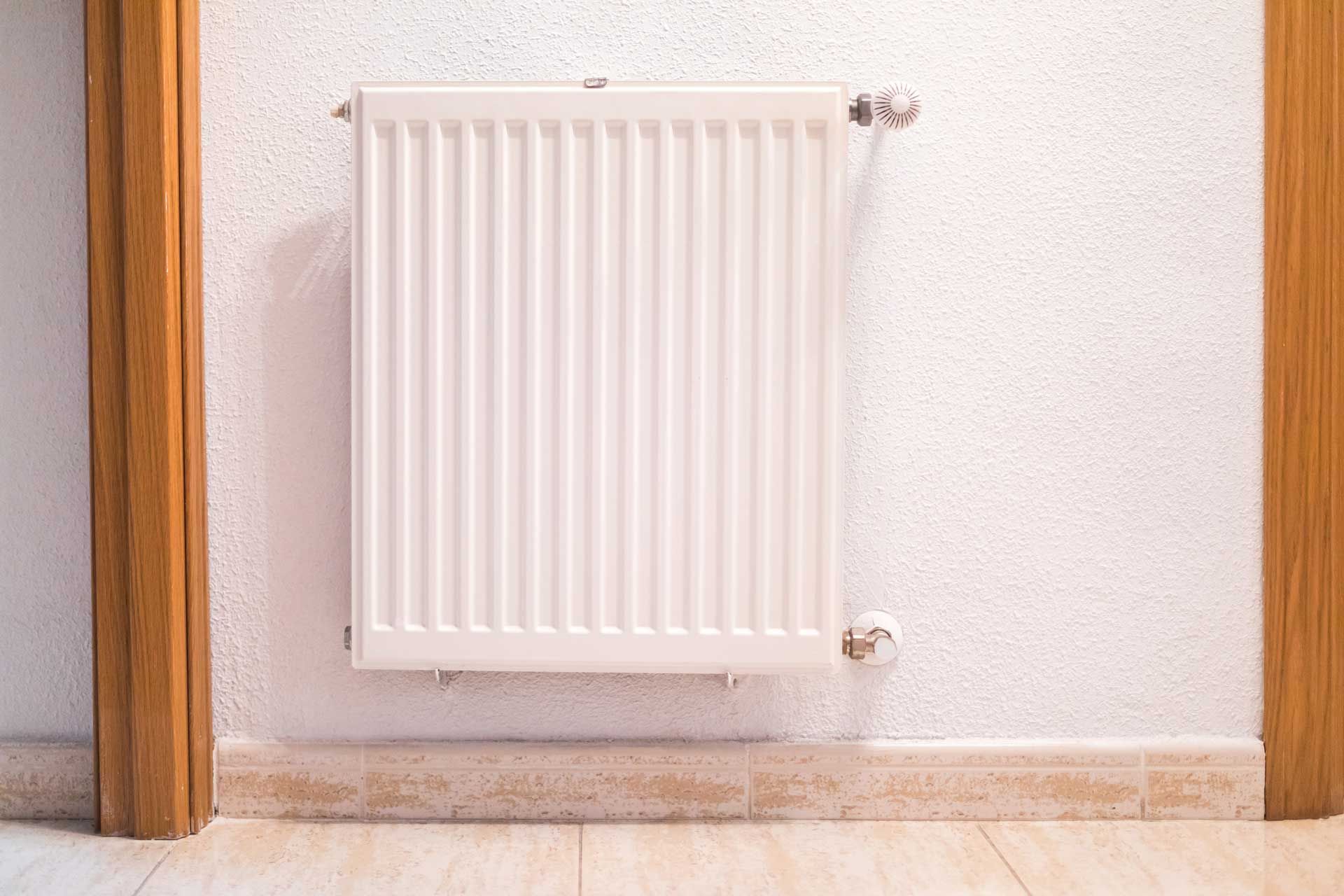 White iron heating radiator inside a house, showcasing furnace replacement in Nicholasville, KY.