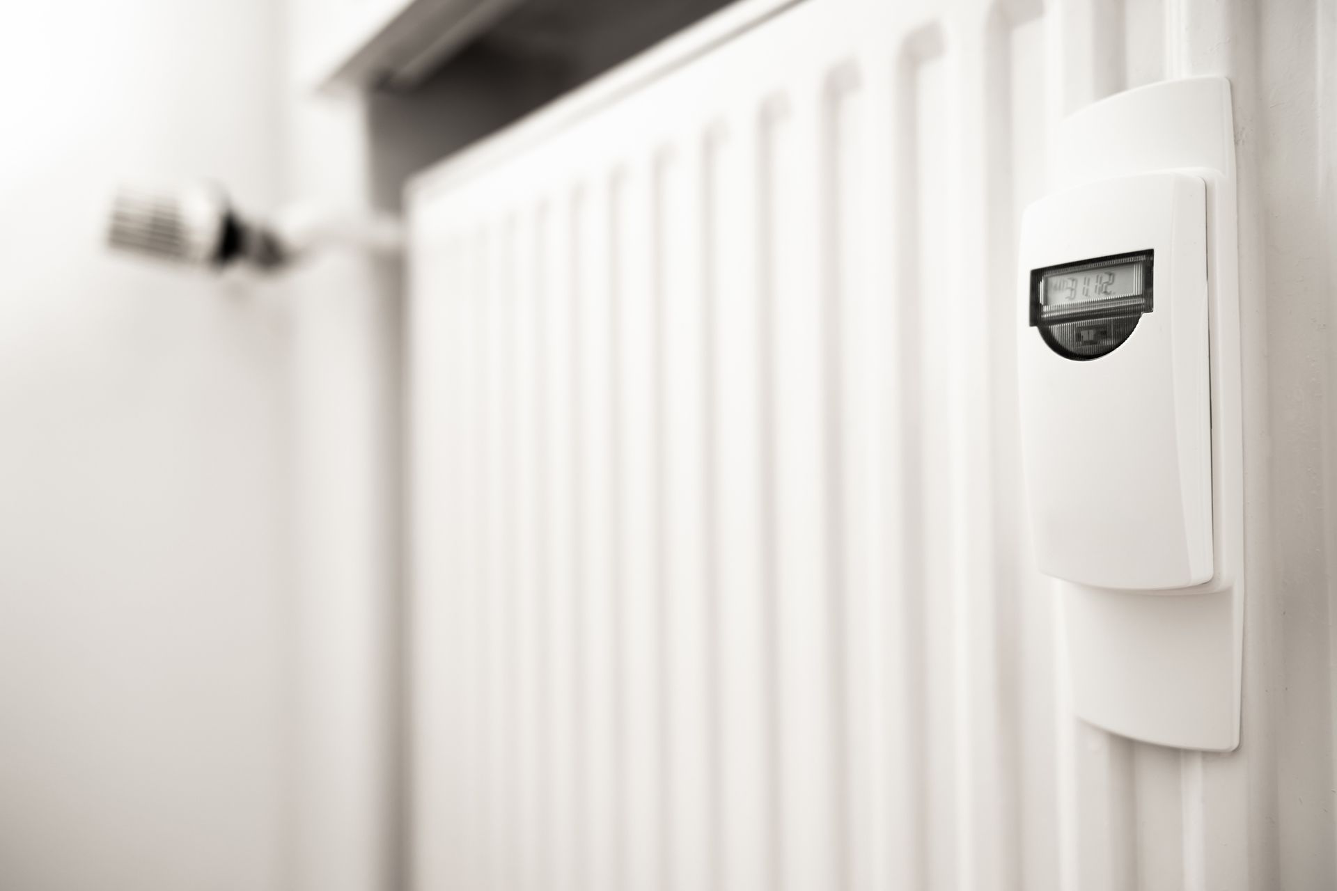 White radiator with digital thermostat showing 19.2°C.