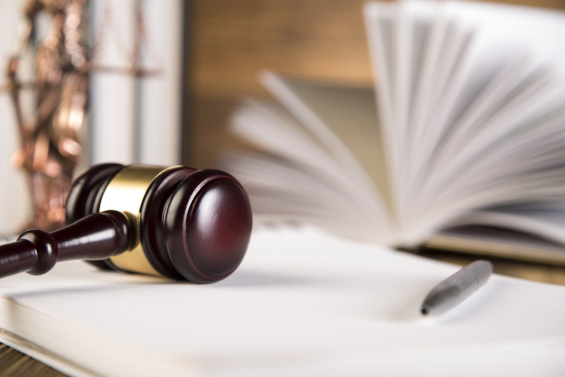 Gavel and books on wooden table — Law firm in Augusta, ME Gavel and books on wooden table — Law firm in Augusta, ME