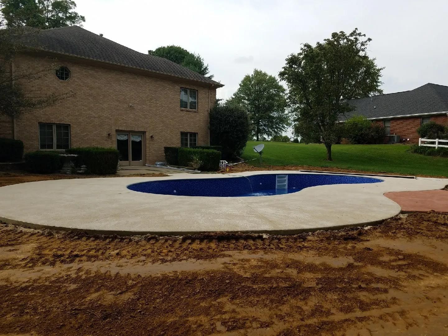 A large house with a swimming pool in front of it