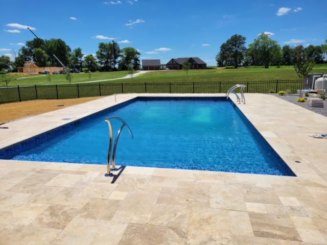 A large swimming pool with a fence around it