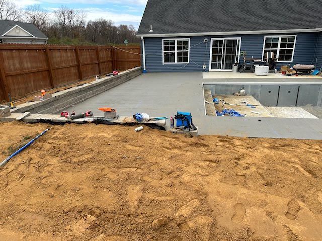 A swimming pool is being built in the backyard of a house.