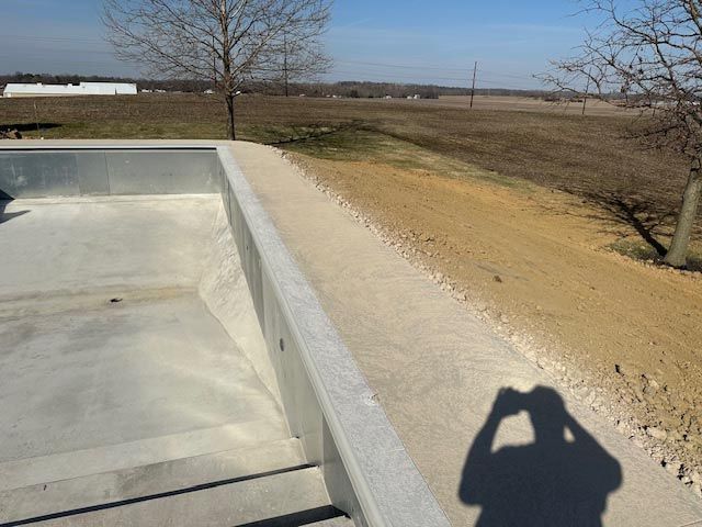 A shadow of a person taking a picture of a dirt road