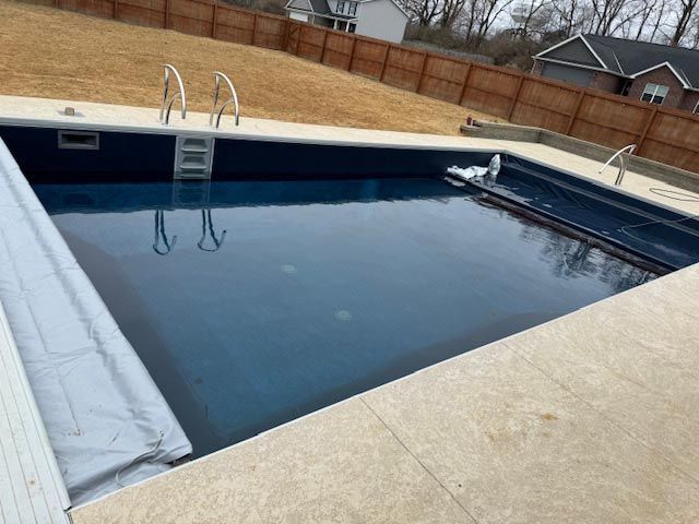 A large swimming pool with a ladder in the middle of it.