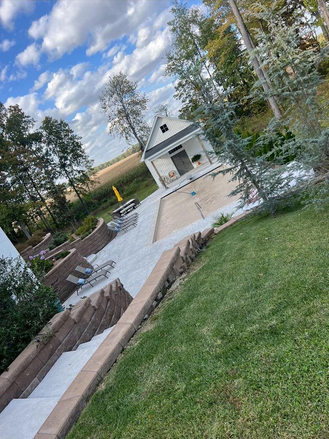There is a swimming pool in the backyard of a house.