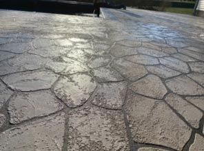 A close up of a concrete walkway with a geometric pattern.