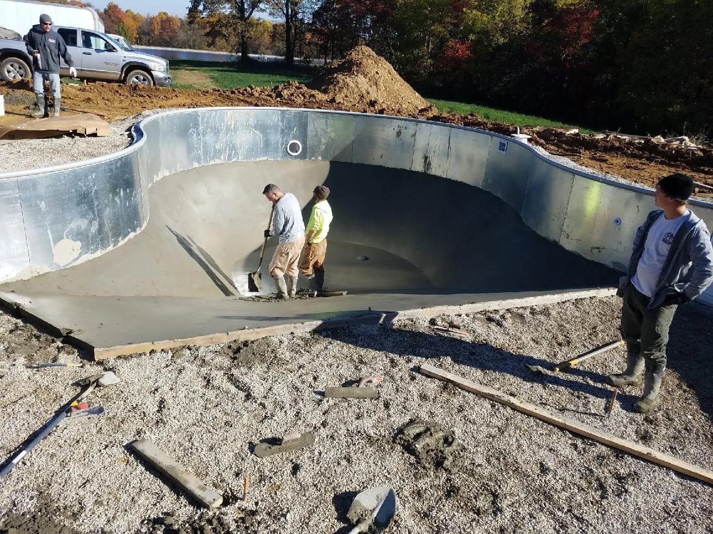 A group of men are working on a swimming pool