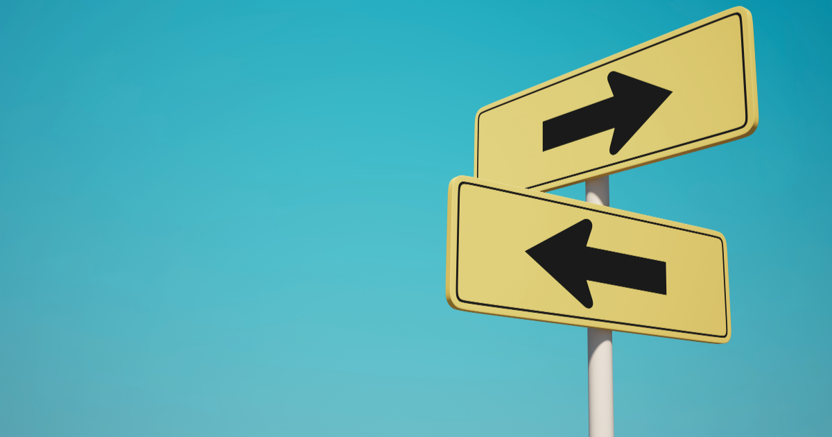 two yellow arrow road signs against a blue sky representing decisions