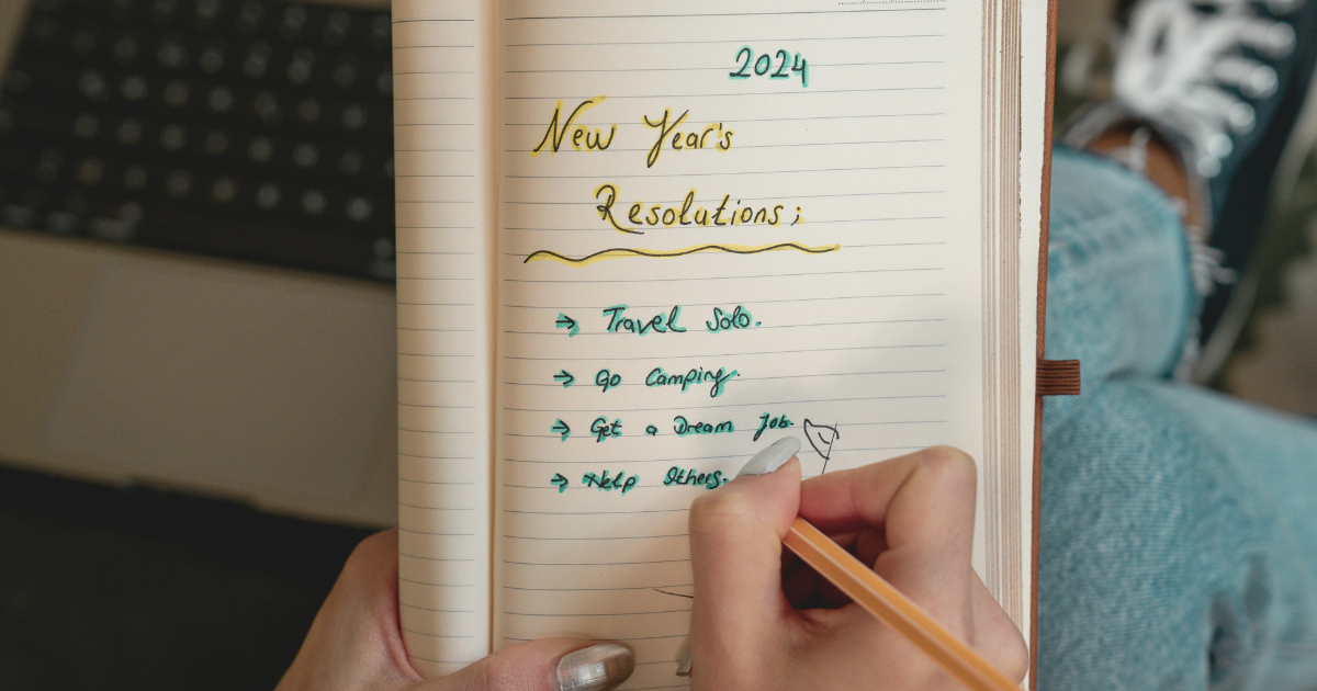 Close-up of a journal listing four New Year's resolutions.