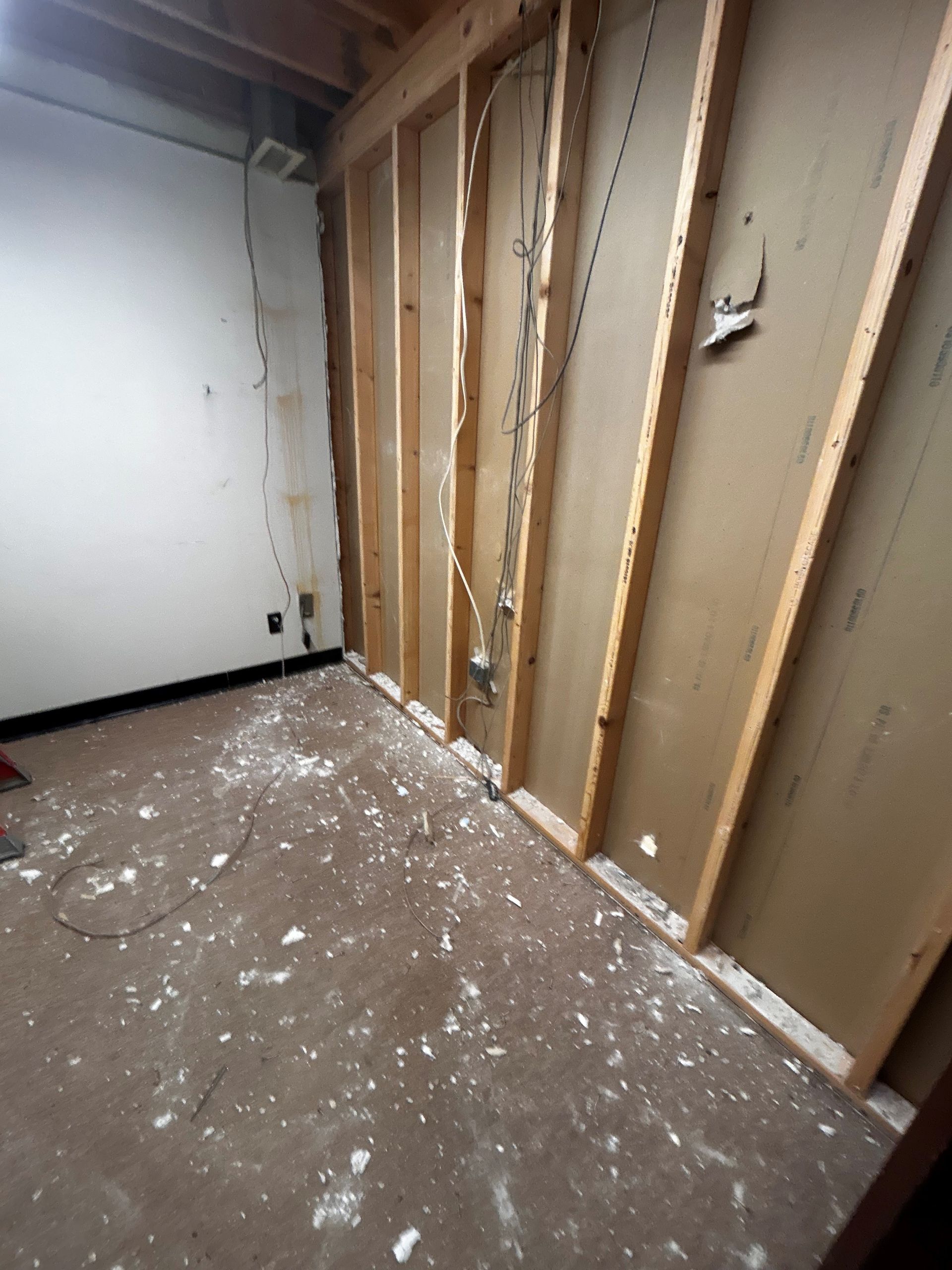 A woman is swinging a golf club on a golf course.