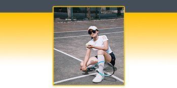 A woman is sitting on a tennis court with a tennis racquet. A woman is sitting on a tennis court with a tennis racquet.