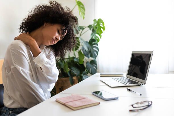 A woman is suffering from neck and shoulder pain.