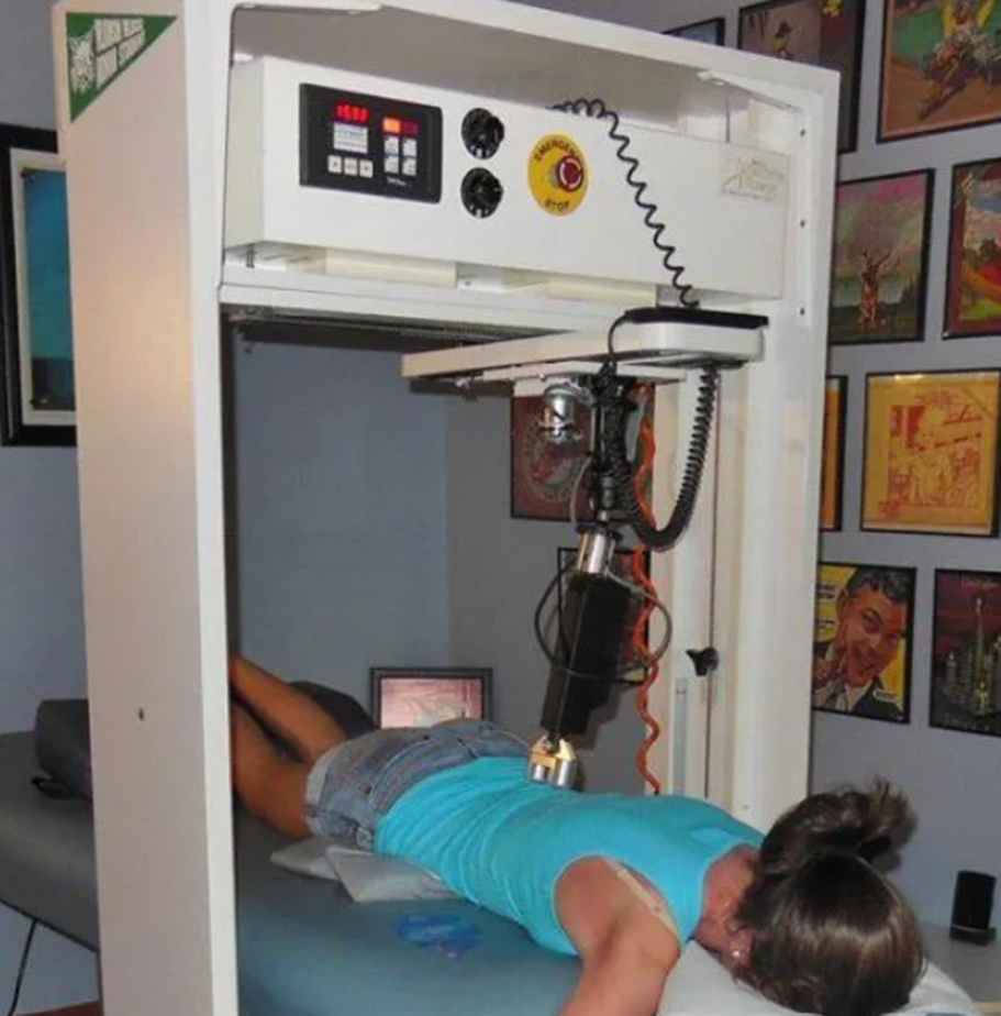 Back pain treatment using a specialized therapeutic machine with a robotic arm. Back pain treatment using a specialized therapeutic machine with a robotic arm.